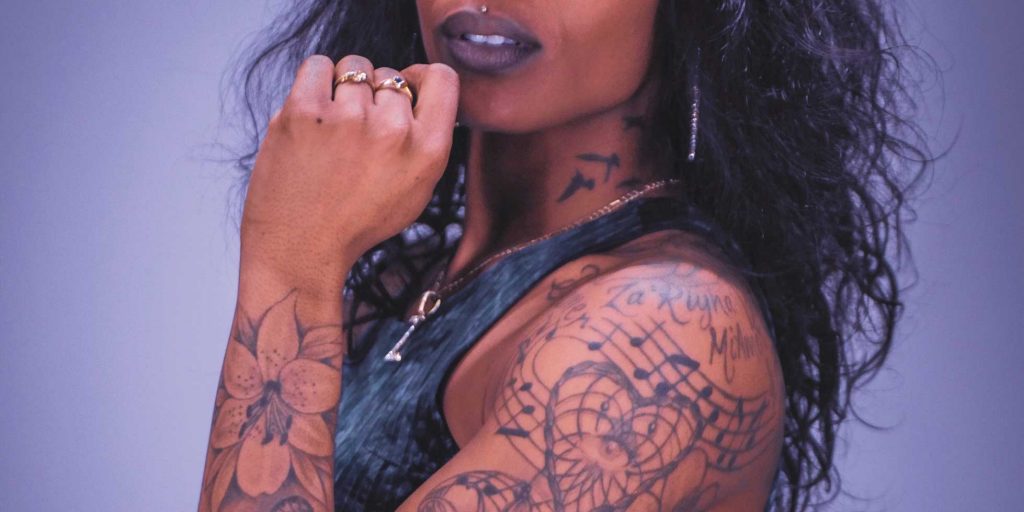 Woman with tattoos on dark skin