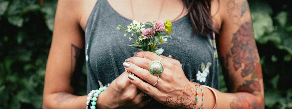 womens fashion tattooed woman holding flowers